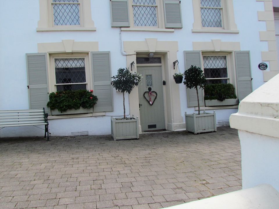perfect house with bay trees either side of front door