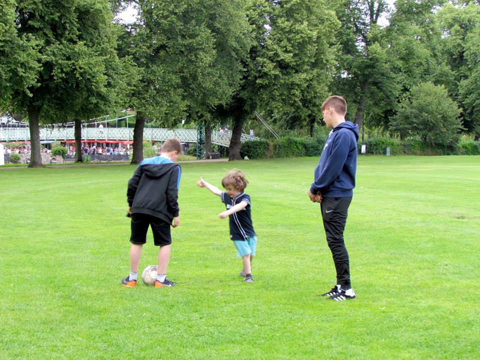 playing football in the park
