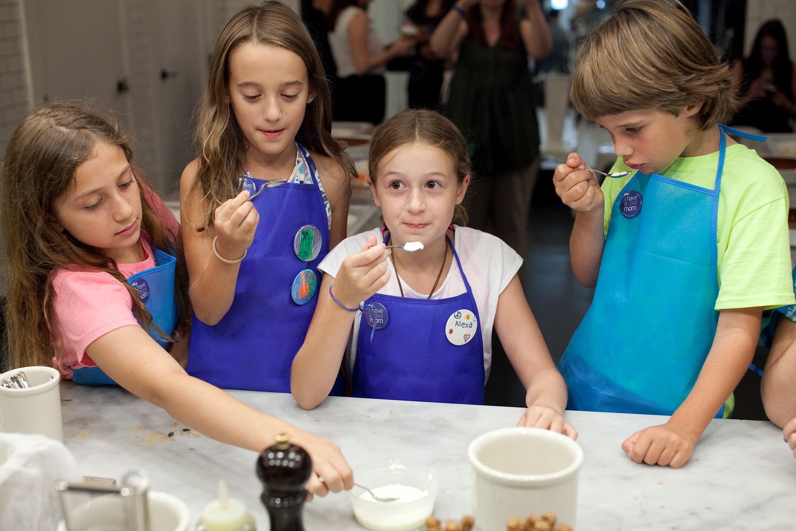 Healthy yogurt snack recipes: Kids making homemade yogurt parfaits at Haven's Kitchen | © Cool Mom Picks