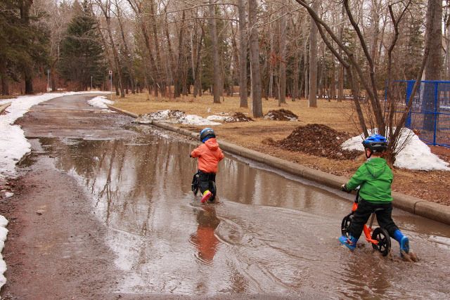 How to make driveway bike riding more fun: Biking in Puddles at Family Adventures in the Canadian Rockies