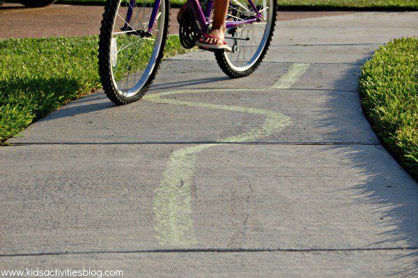 SMaking driveway bike riding more fun: Slow racing idea from Kids Activities Blog