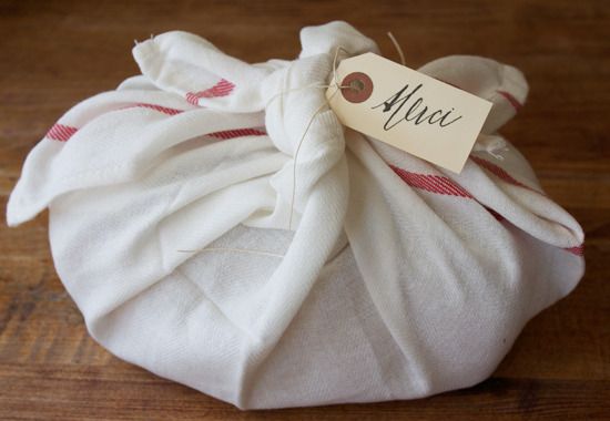Christmas cookie gifts wrapped in a new tea towel as shown on Make & Takes