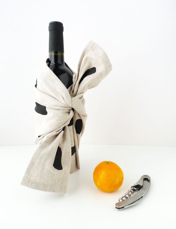 Use a gorgeou tea towel to make a furoshiki wine wrap. It's a perfect, easy hostess or holiday gift | Cotton and Flax