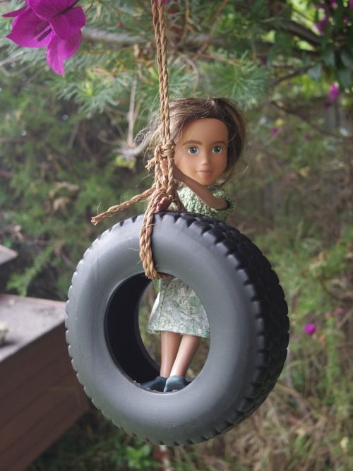 Tree Change Doll on tire swing