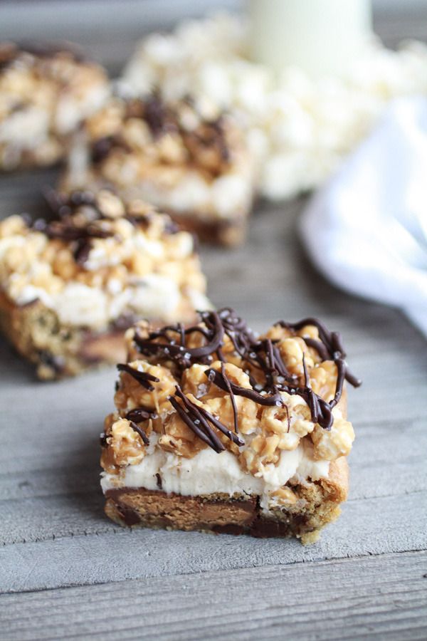 Wow, a spectacular way to use leftover Halloween candy: Peanut Butter Cup Cookies Cream Salted Caramel Popcorn Bars | Half Baked Harvest