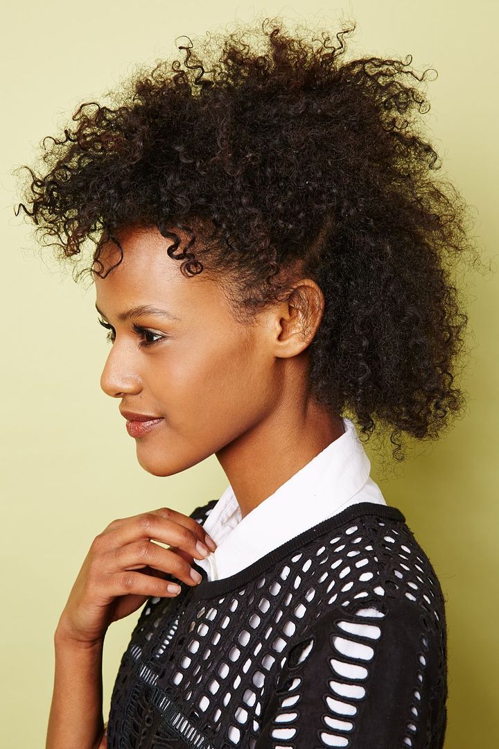 Easy hair tutorials for naturally curly hair like this one-third updo from Refinery 29