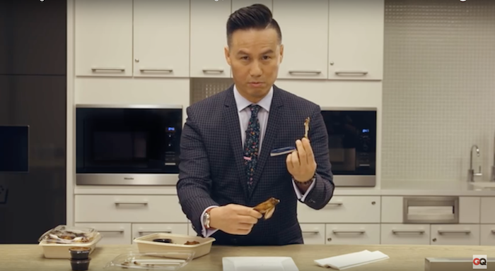 B. D. Wong teaches us how to eat a chicken wing like an expert.