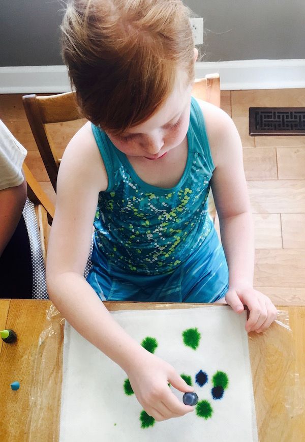 Step 2 for tie-dying Easter eggs: use food coloring to make a pretty pattern.