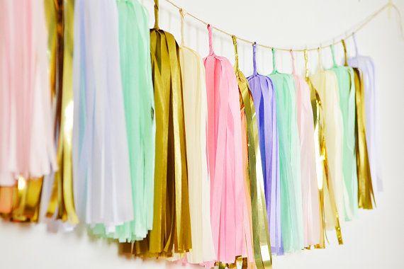 Unicorn birthday party ideas: rainbow bunting from GenWoo at Etsy.