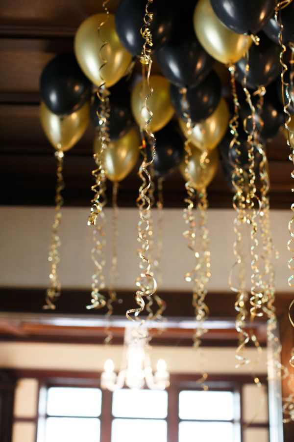 Hamilton party ideas: black and gold balloon entrance idea by Style me Pretty
