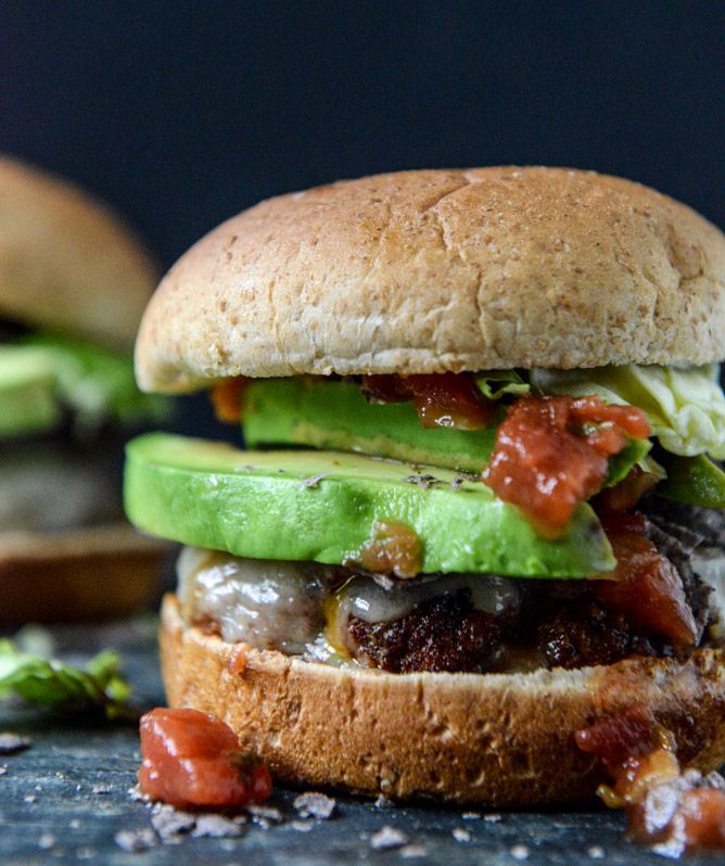 Can't decide between Mexican and American fare for dinner? Try these Taco-Rubbed Burgers with Avocado and Crushed Tortilla Chips. You won't regret it! | How Sweet It Is